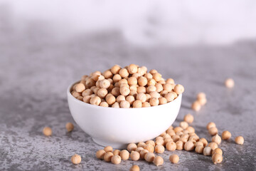 raw chickpeas are lying on a gray table