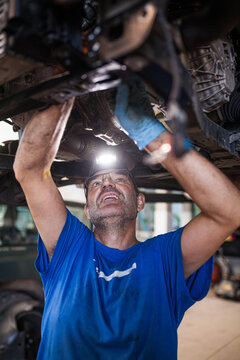 Man fixing modern car in service