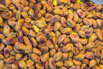 Background made of mixed nuts. Healthy snack and food. Salted and spicy pistachios, cashew and...