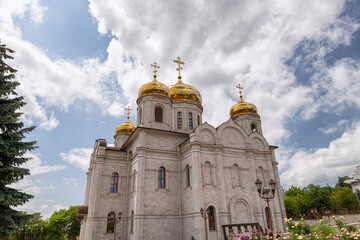 Large Orthodox church with white-stone facade and gilded domes