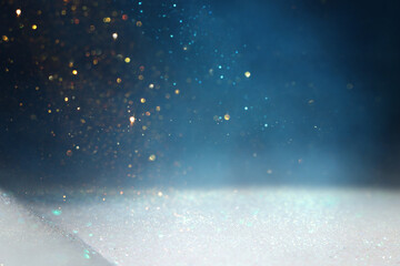 background of abstract glitter lights. gold, blue, silver and black. de focused