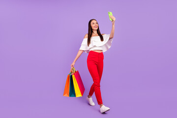 Profile photo of lady walk carry bargains take phone selfie wear white blouse pants isolated violet color background