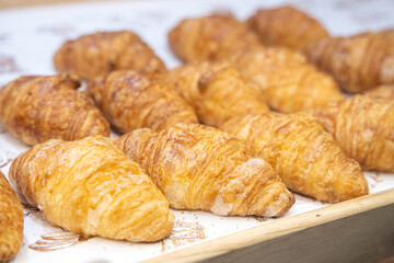 Croissants in a tray weave in a bakery shop.