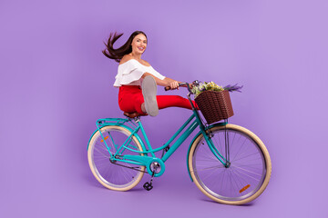 Profile photo of active lady enjoy bike ride raise legs wear white blouse trousers shoes isolated purple color background