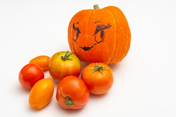 Ripe vegetables - pumpkin and tomatoes on a white background. Red and orange vegetables are a source of carotene