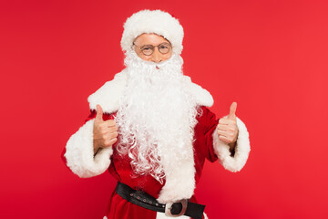 Santa claus in costume showing like gesture isolated on red