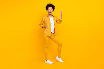 Full length photo of young black lady celebrate victory success win lottery isolated over yellow color background