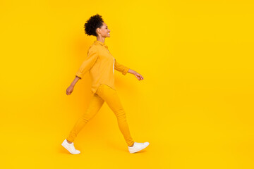 Fototapeta na wymiar Full length body size photo woman smiling wslking on meeting isolated vivid yellow color background