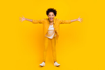 Full length photo of young cheerful afro girl open hands welcome hug hospitable isolated over yellow color background