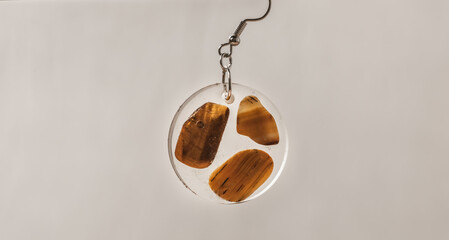 Hand made pendant earring in synthetic transparent resin with color stones