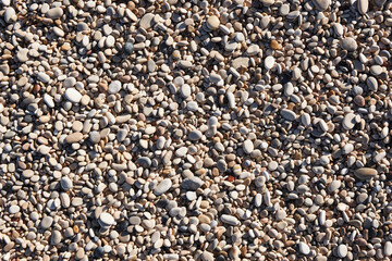 Mediterranean shoreline pebble beach. Stone nature background.