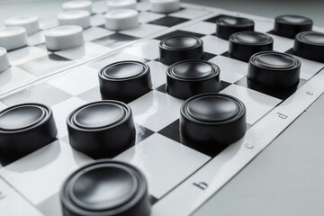 Chess board with checkers. Hobby. checkers on the playing field. Board games. Black and white checkers. - obrazy, fototapety, plakaty