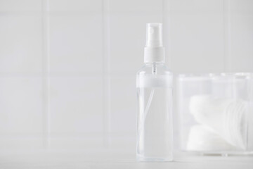 Tonic or facial lotion in a clear plastic bottle on a white background. Daily skin care. Copy space.