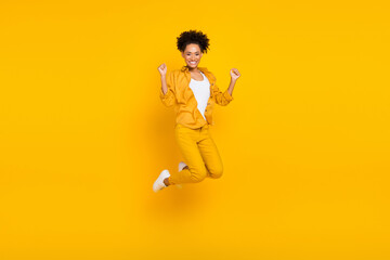 Fototapeta na wymiar Full length body size photo woman jumping up gesturing like winner isolated vivid yellow color background