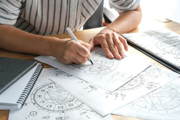 Astrology. Astrologer calculates a natal chart and makes a forecast of fate. Astrological forecast, mysticism, science. Astrological background. © shintartanya
