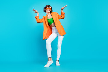 Full length photo of pretty millennial brunette lady dance wear blazer spectacles top jeans shoes isolated on teal background