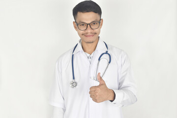 Portrait of doctor with stethoscope and showing thumb up on white background.