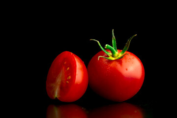 Washed cherry tomatoes on a black background. Close-up view. Healthy eating concept photo