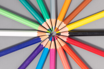 colored pencils forming a circle on gray background