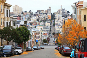 Historic residential buildings on Greenwich Street at Grant Avenue with Russian Hill at the background, city of San Francisco, California CA, USA. 