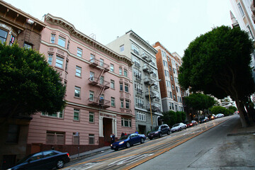 Historic buildings on Powell Street with large slope near Bush Street in city of San Francisco,...