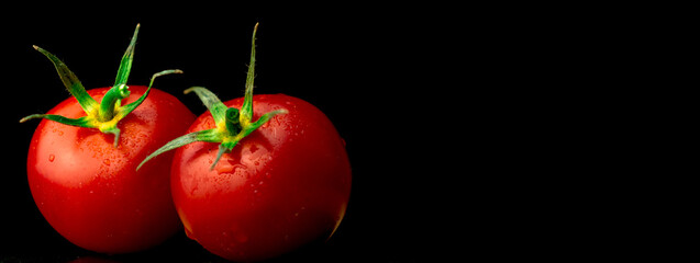 Fresh cherry tomatoes on a black background, banner with copy space. Cooking, healthy eating, organic vegetable food concept