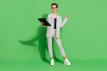 Photo of adorable pretty young woman dressed checkered clothes writing clipboard smiling isolated green color background