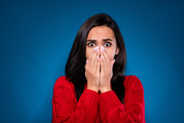 Photo of pretty scared young woman dressed red pullover arms close lips nose face isolated dark blue color background