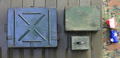 ammunition boxes on green wooden background