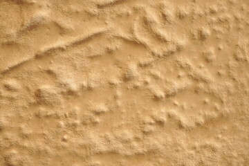 Concrete wall with plaster. Light brown cement or stone old texture. Rough lighted retro surface. Vintage background for designers.