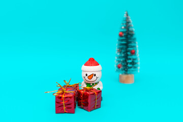 Toy snowman, presents and Christmas tree with copy space.new year celebration.