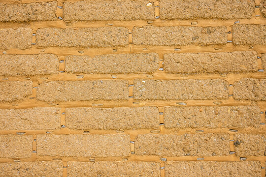 Detail of old adobe brick wall for background or texture. Mud brick background to add your text. Rustic textures concept for greegar your design. Amatlán, Mexico.