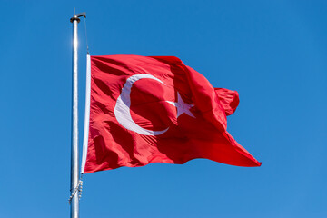 Big Turkish flag waving in the blue sky