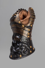 Medieval knightly brown plate gauntlet from Italian armor, in the form of a lion's face and mane,...