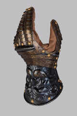 Medieval knightly brown plate gauntlet from Italian armor, in the form of a lion's face and mane,...