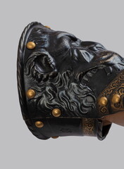 Medieval knightly brown plate gauntlet from Italian armor, in the form of a lion's face and mane,...