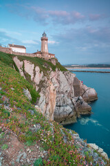 Fototapeta na wymiar Beautiful lighthouse at dusk. Coast in northern Spain.