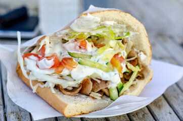 Doner kebab as a sandwich. Doner kebab is a type of kebab, made of meat cooked on a vertical rotisserie.