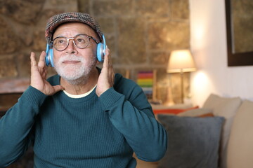 Senior retired man listening to music with joy