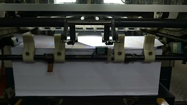 A modern four colour printing machine running in high speed. Shot at Kolkata, West Bengal, India.