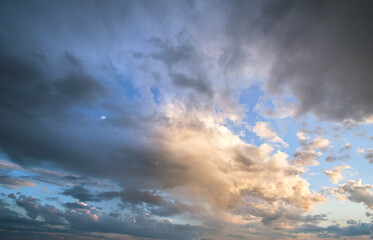 Fototapeta na wymiar Bright landscape of dark clouds on yellow sunset sky in evening.