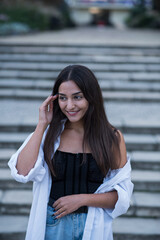 Portrait of a beautiful, happy and attractive Caucasian or Arabian brunette girl dressed in casual style.