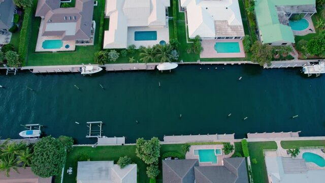 Aerial flight over beautiful homes on a Florida canal