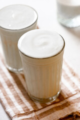 Homemade kefir or yogurt in glasses close-up. Fermented milk drink, kefir with prebiotics. Healthy food or drink.