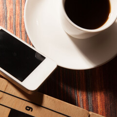 Chess, a cup of black coffee and a smartphone. Good mind