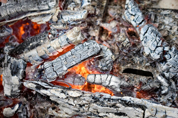 Burning coals in a fire with flames