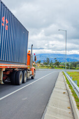 orange truck with a blue container on the road © SergioNicolas