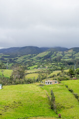 Lonely house in the field with colombian mountains
