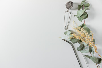 Frame with straw, cleaning brush and tea strainer on white background. Flat lay, top view, copy...