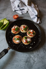 View from top of Italian snack mini pizzas in a cooking pan.